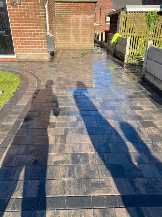 Brindle block paving driveway laid between two houses by North West Landscapes, freshly jointed
