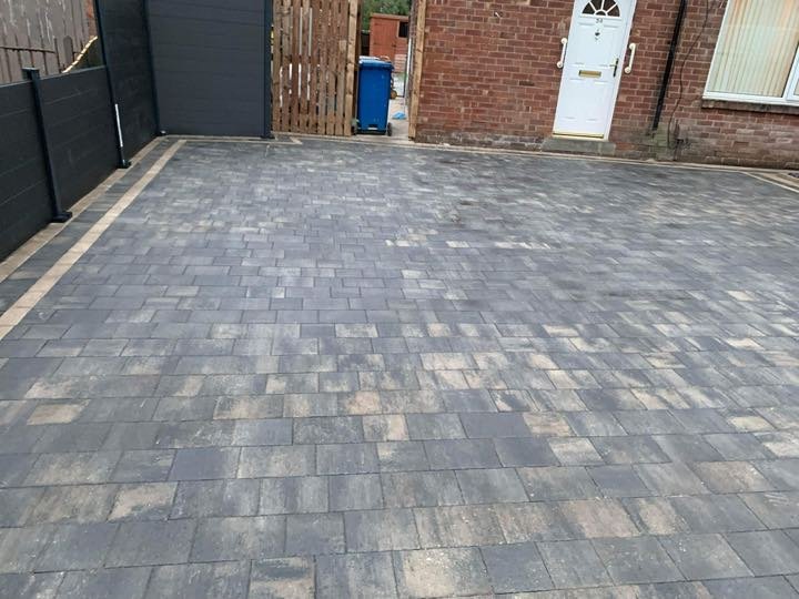 Charcoal grey block paving driveway laid at the front of a house by North West Landscapes