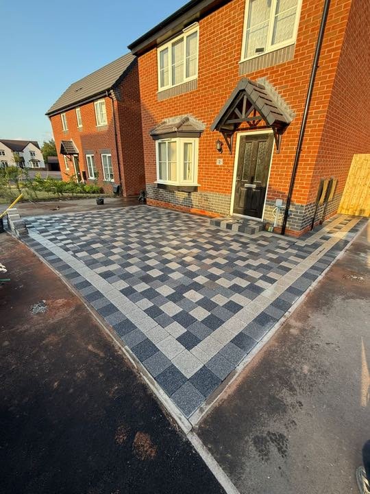 Charcoal and silver granite checkerboard block paving driveway by North West Landscapes
