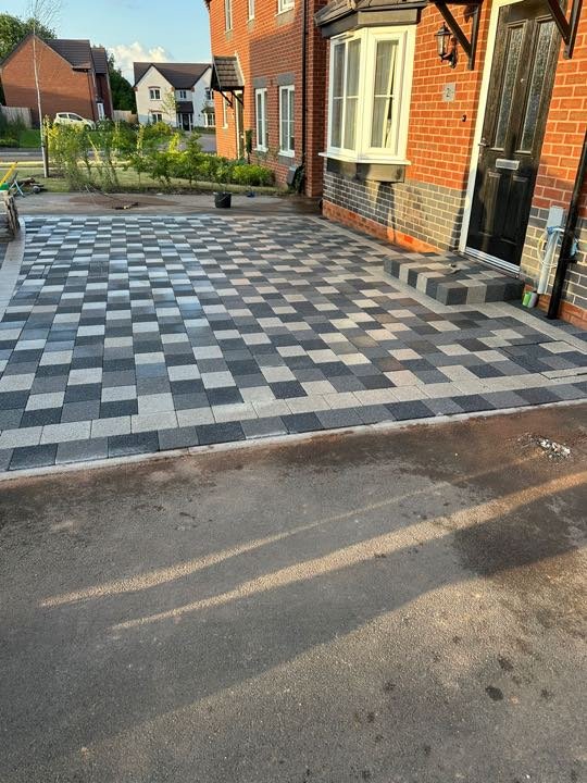 Charcoal and silver checkerboard block paving driveway by North West Landscapes
